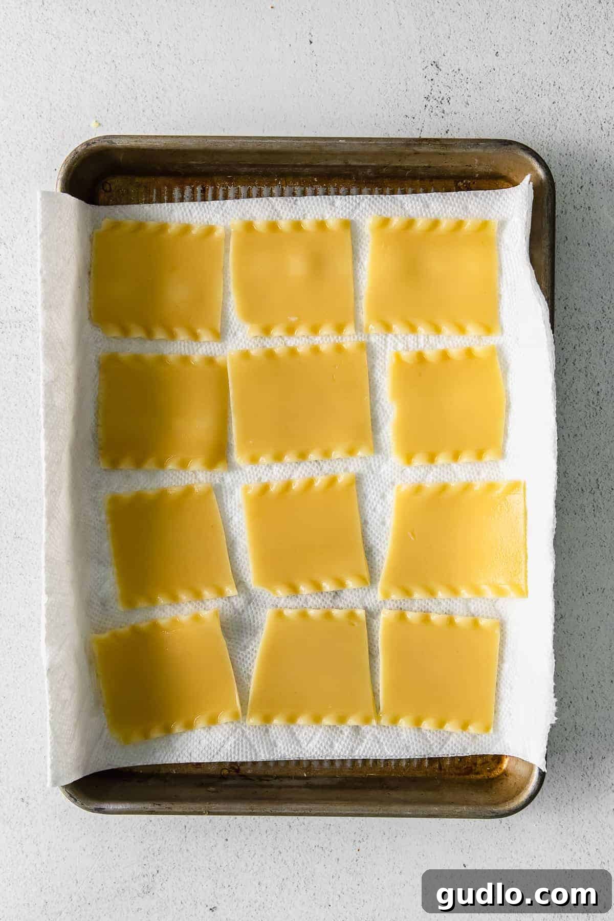 Cooked lasagna noodles laid out on paper towel to dry