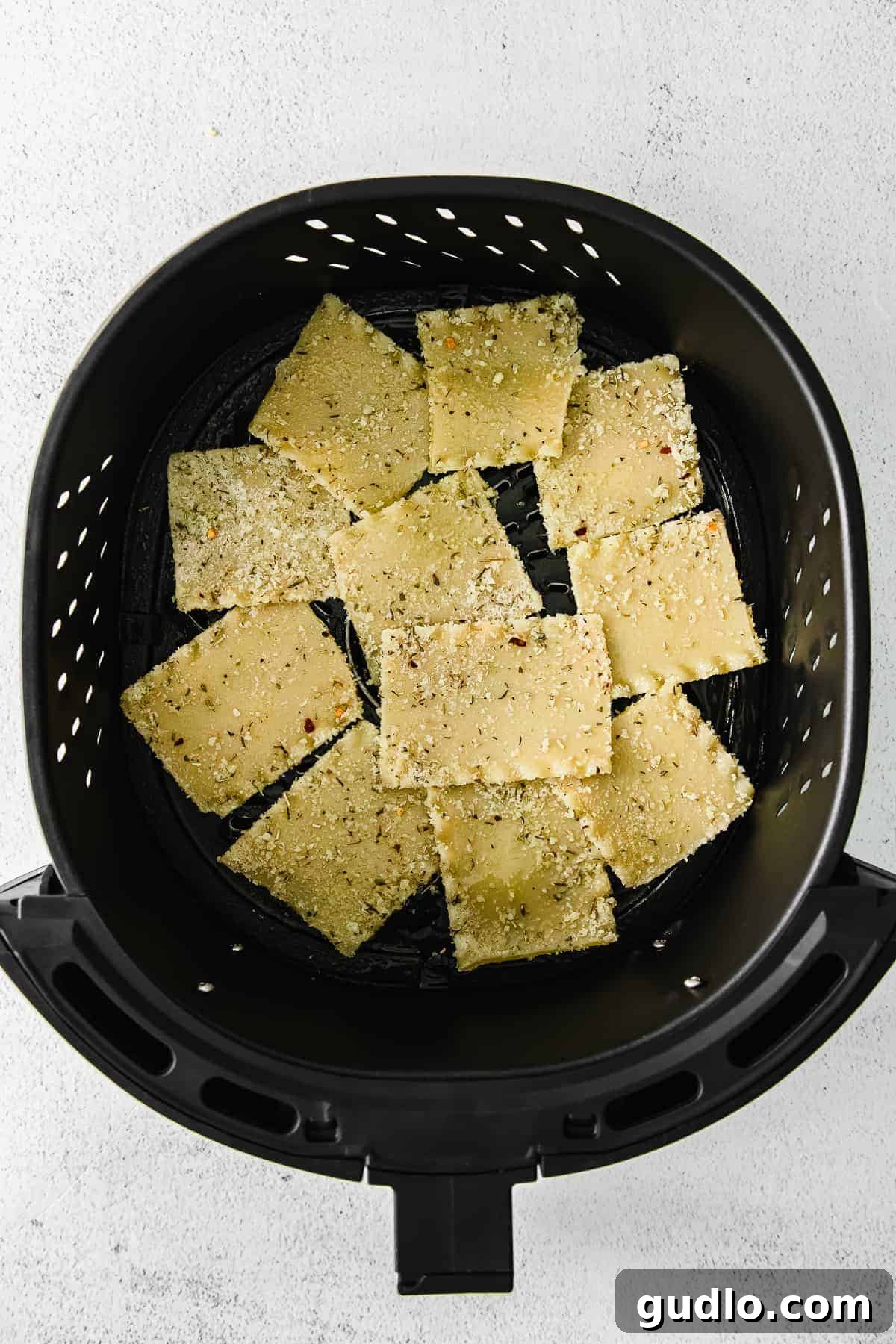Lasagna noodles cooking in an air fryer basket