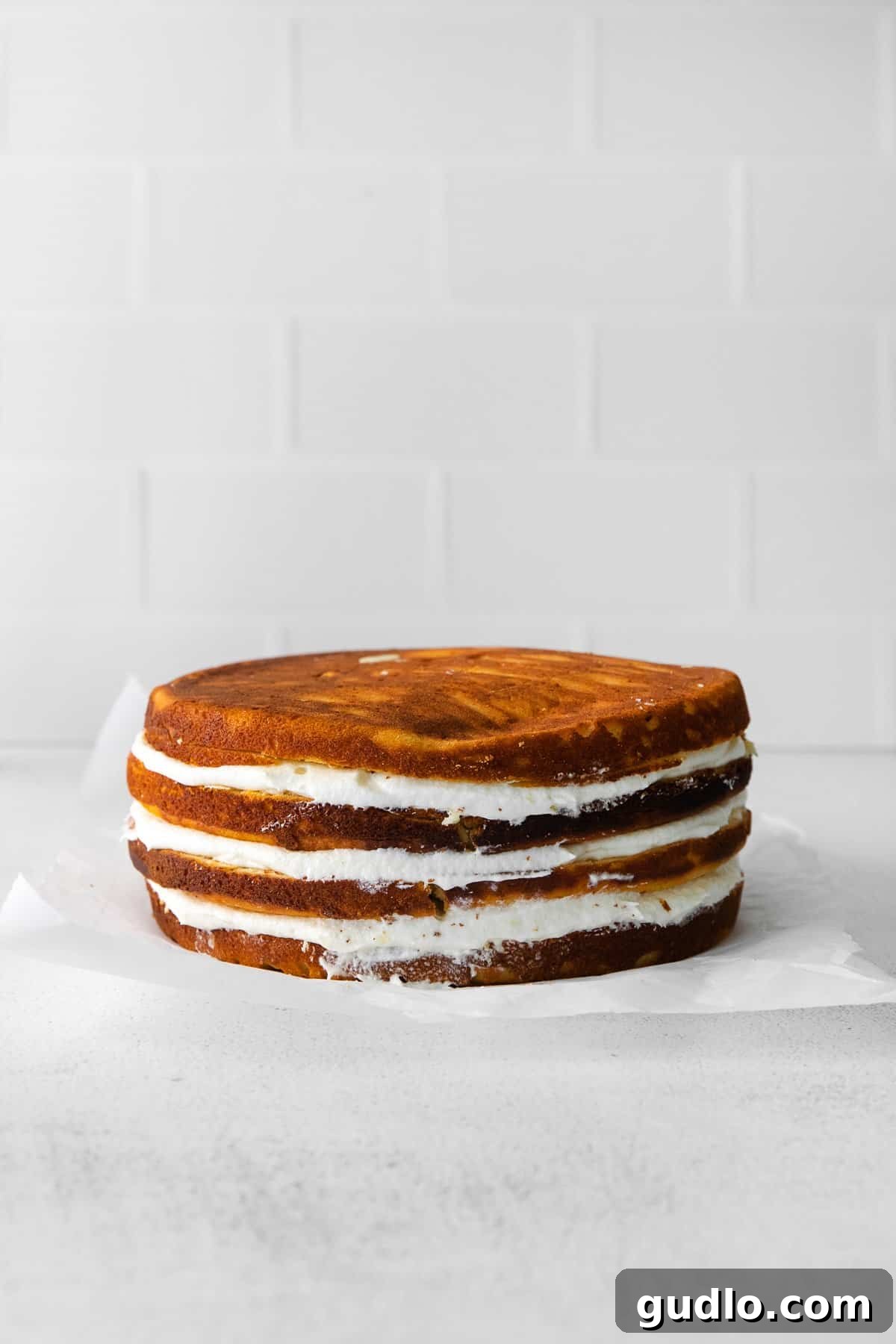 Dreamy Strawberry Ricotta Layer Cake 10 An assembled ricotta layer cake with cream cheese frosting, showing the layers of cake and filling, ready for its final decoration.