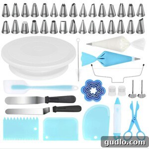 Dreamy Strawberry Ricotta Layer Cake 4 A comprehensive cake decorating kit featuring various spatulas, piping bags, tips, and a cake turntable, neatly arranged for easy access.