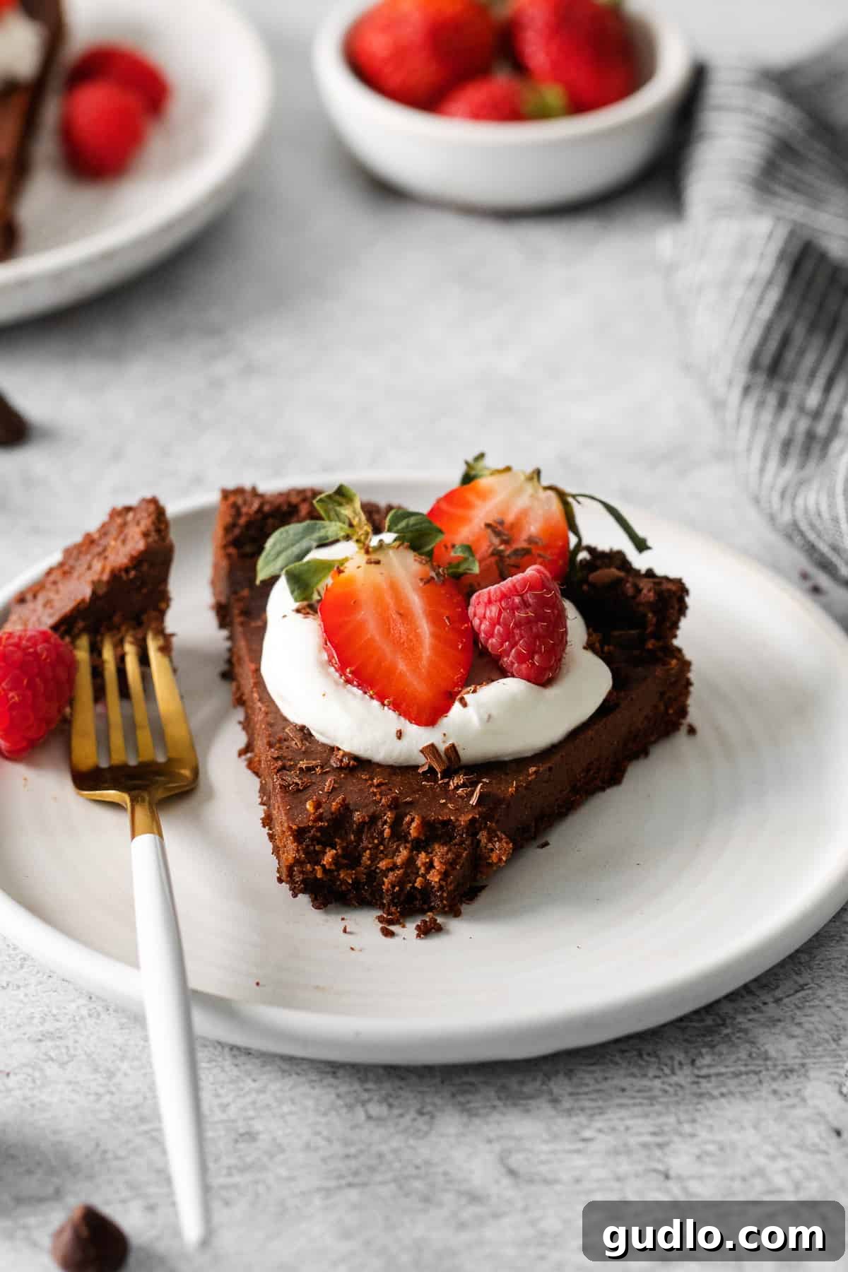 A beautifully presented slice of a chocolate tart, showcasing its rich, creamy filling and flaky crust.