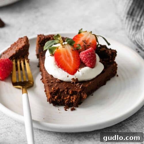 A slice of chocolate tart, perfectly presented and ready to eat.