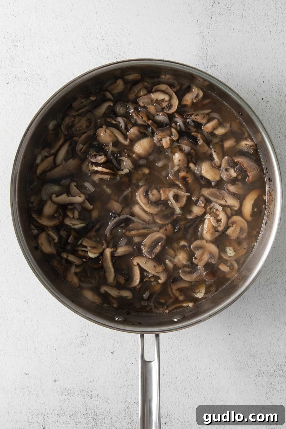 mushroom pasta sauce in skillet, glistening and rich