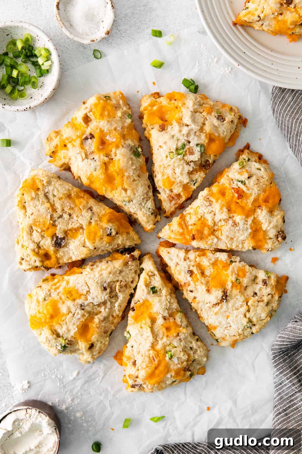 Delicious Bacon Cheddar Buttermilk Scones Recipe Golden-brown Bacon Cheddar Scones arranged beautifully on a wooden countertop, showcasing their crispy edges and tender texture, ready to be enjoyed.
