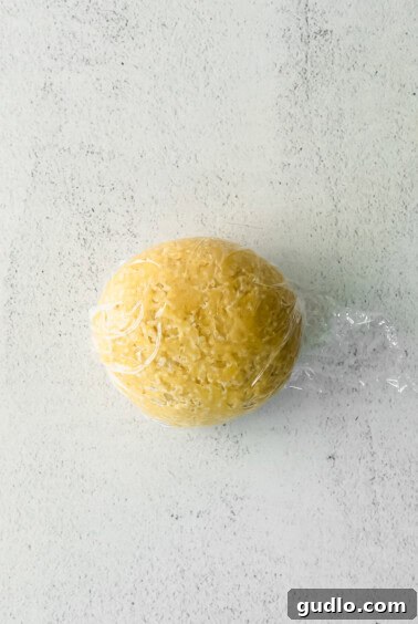 A homemade ball of pasta in a plastic bag on a white surface.