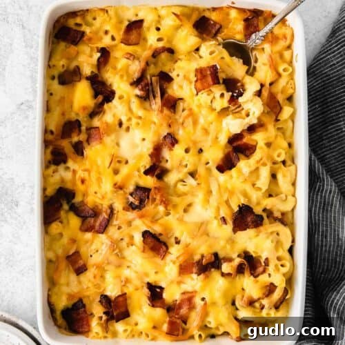 macaroni and cheese with bacon in a baking dish.