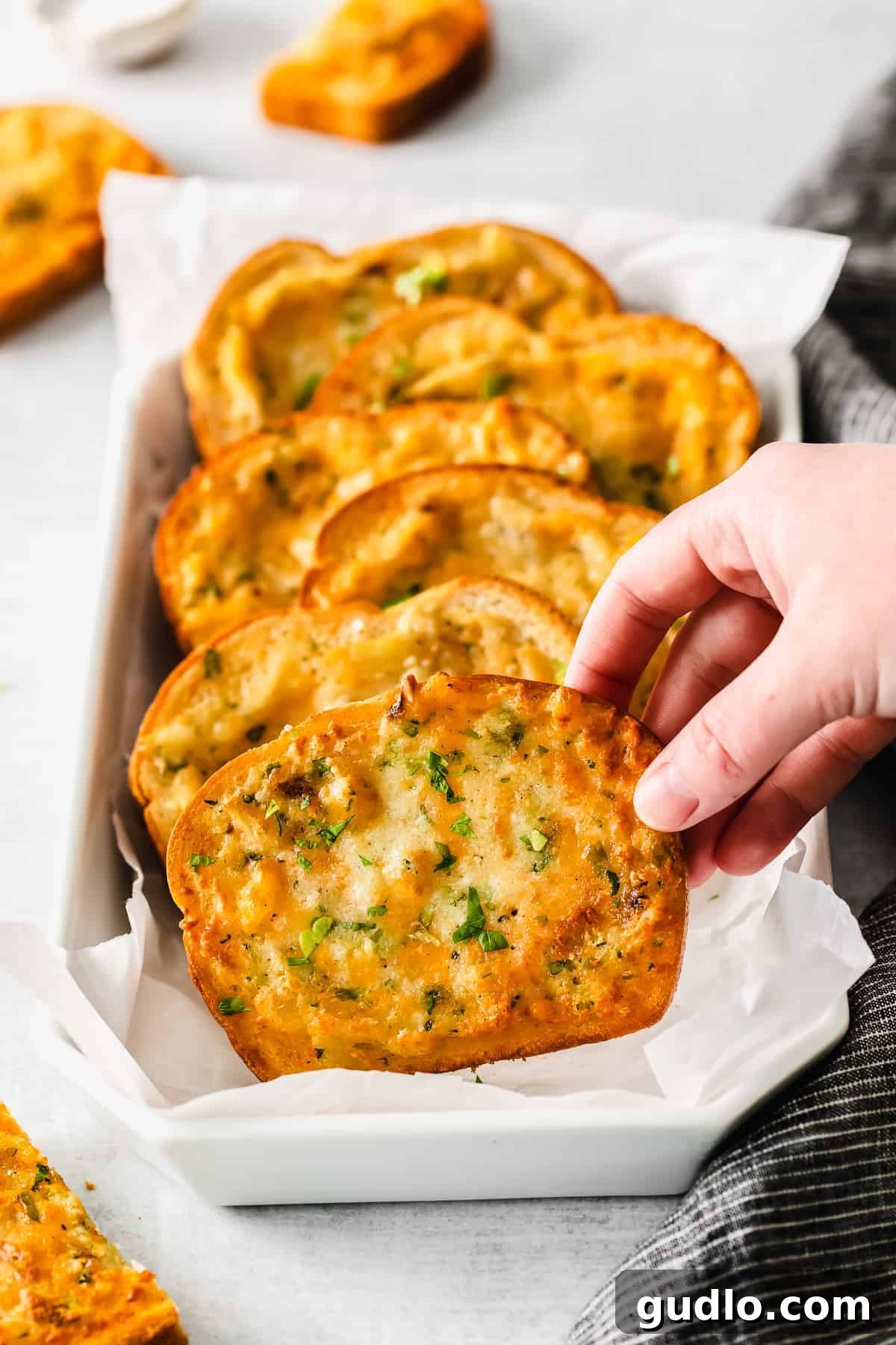 Ultimate Air Fryer Texas Toast with Garlic and Cheese Golden brown air fryer Texas toast slices arranged on a serving tray, garnished with fresh parsley.