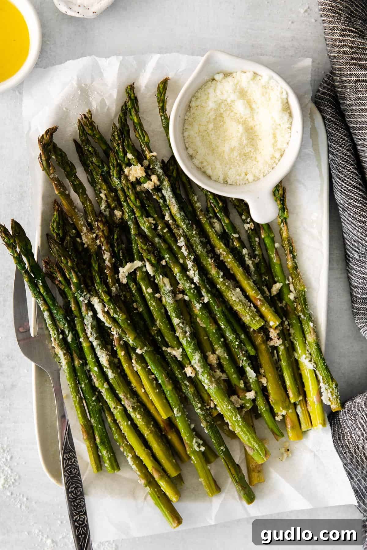 Serving Perfectly Roasted Parmesan Asparagus A freshly roasted parmesan asparagus on a serving plate, inviting and delicious.