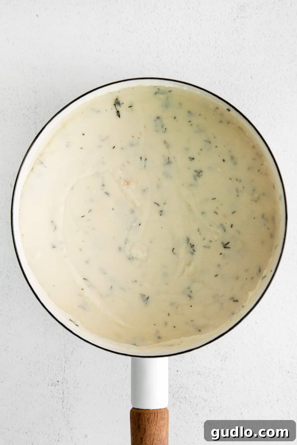 Creamy Garlic Parmesan Sauce 2 A small saucepan filled with rich, creamy garlic parmesan sauce, ready to be served.