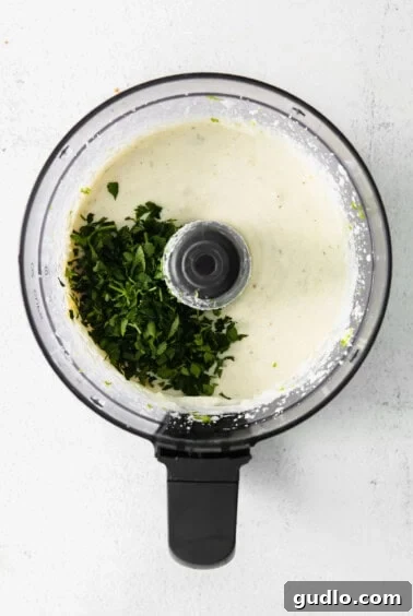 The creamy dip with fresh cilantro added, just before final mixing.