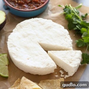 Creamy Fresh Cheese Dip 2 Block of homemade Queso Fresco cheese on parchment paper, ready to be crumbled or used.