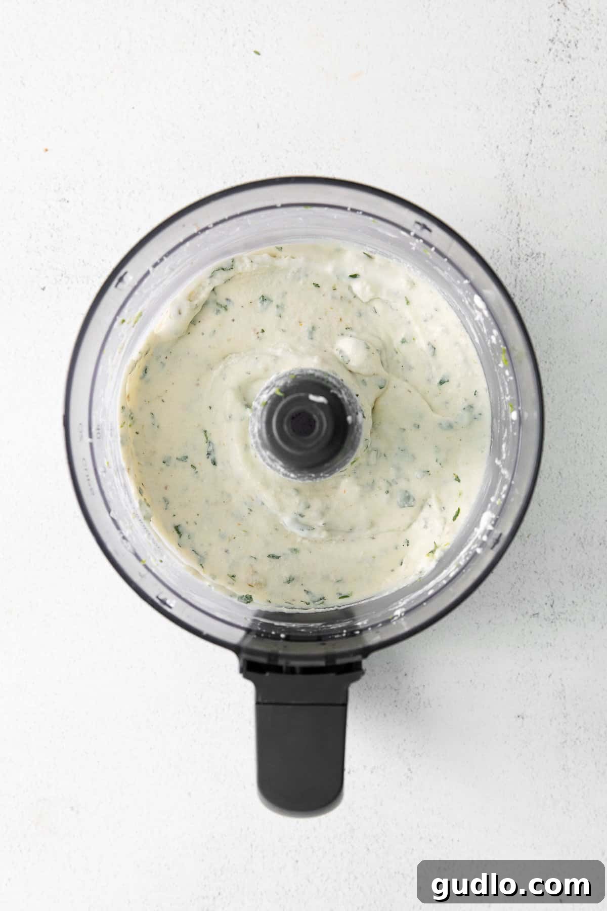 Use this simple recipe for queso fresco cheese dip for chips, raw veggies, or as a topping for enchiladas or quesadillas! The creamy queso fresco dip in the food processor, showing its smooth texture before serving.