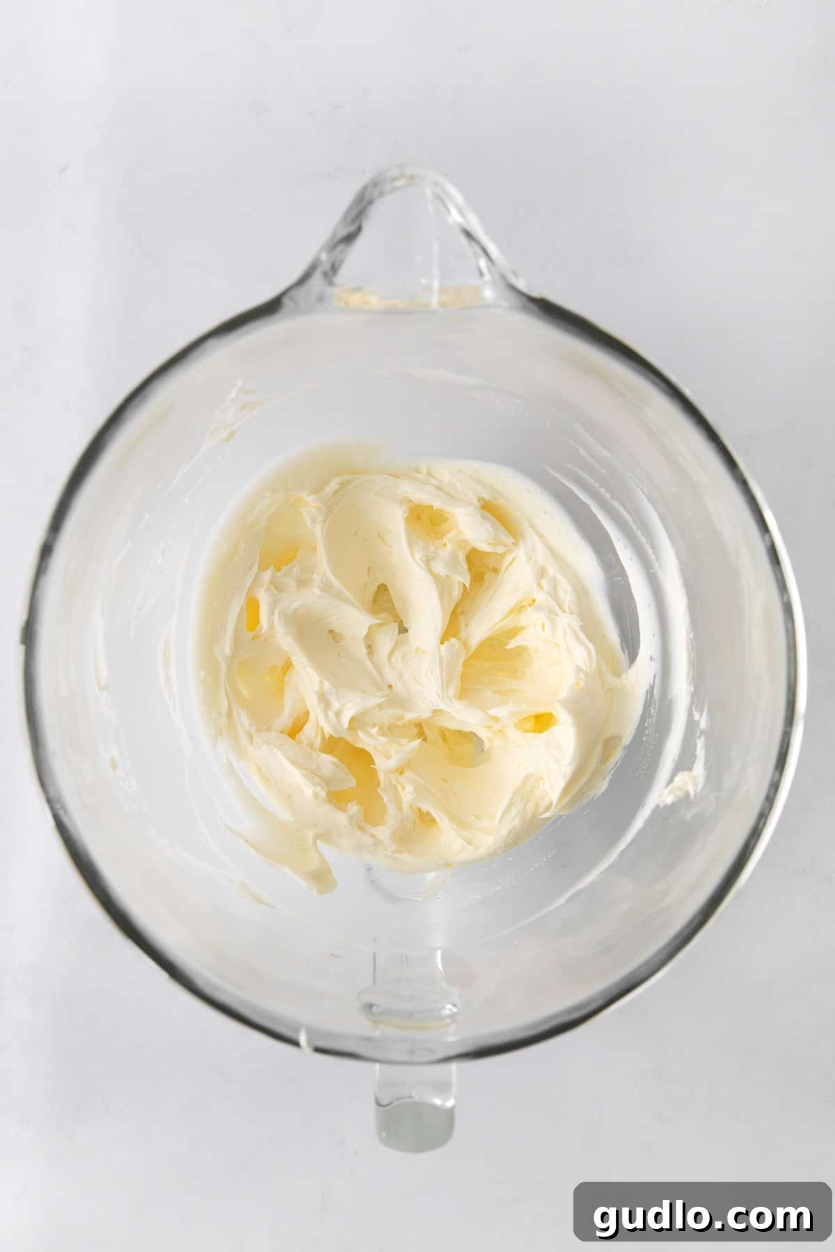 Velvety Vanilla Cream Cheese Frosting 4 Beautifully whipped cream cheese frosting in a mixing bowl, showcasing its light and fluffy texture.