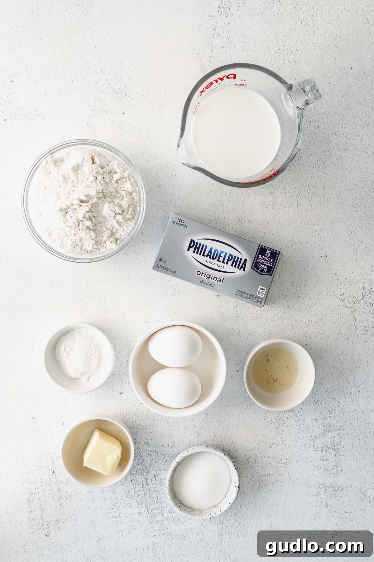 An inviting assortment of fresh ingredients laid out thoughtfully on a kitchen counter, hinting at a delicious cream cheese-based recipe in progress.