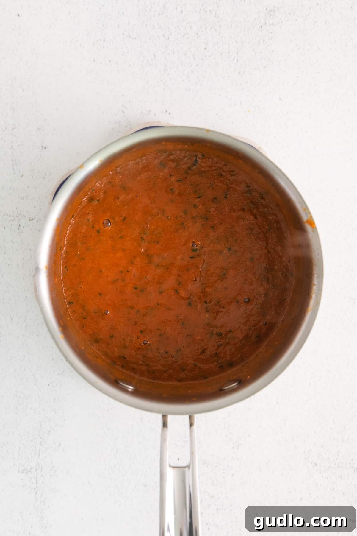 Southwest Breakfast Classic 4 A pot of simmering, rich red ranchero sauce on a stove, ready to be blended.