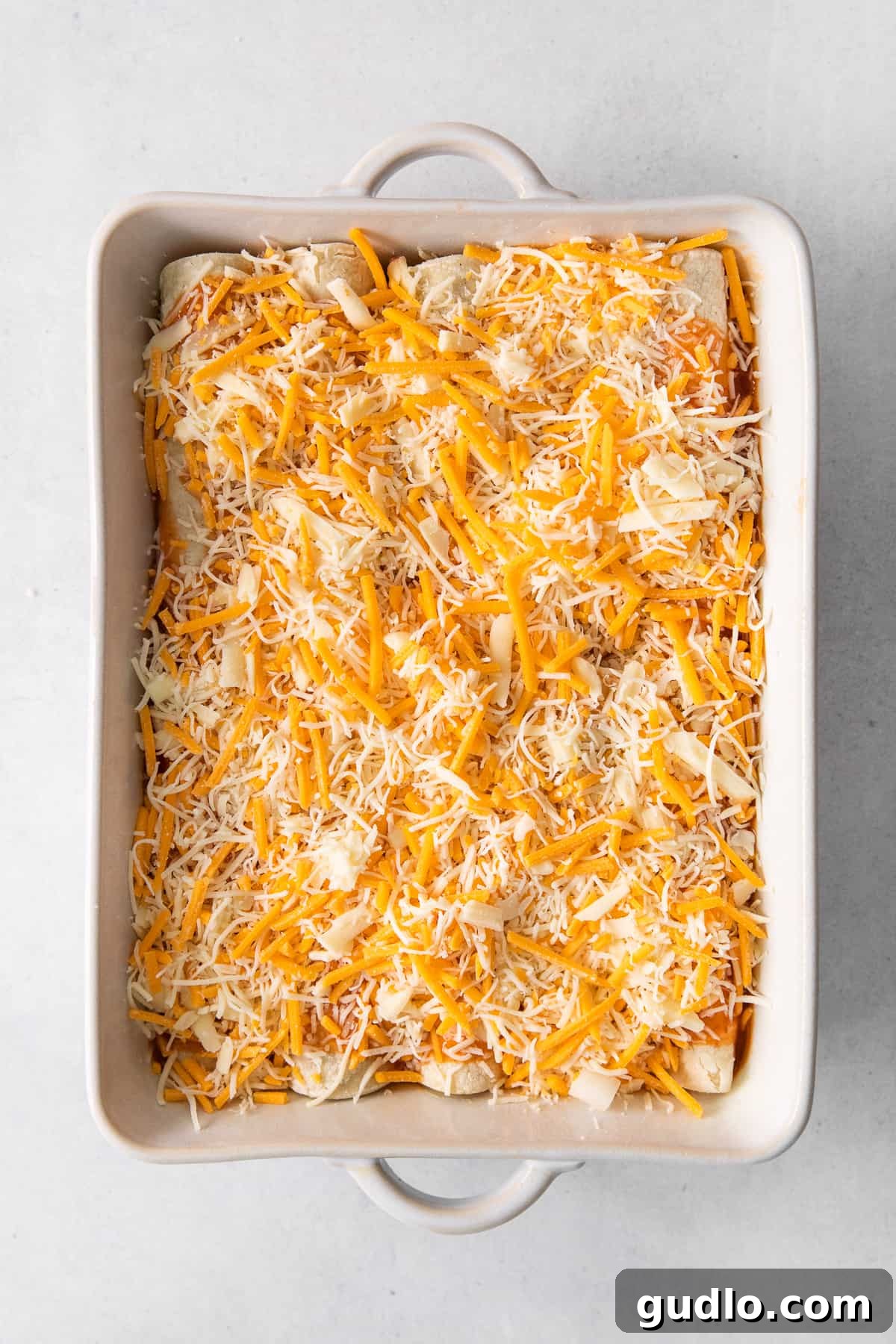 Baked Cheese Enchiladas Fresh from the Oven A casserole dish filled with golden-brown cheese enchiladas, topped with a generous layer of melted shredded cheese.