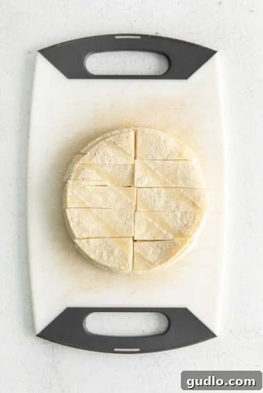 Cheesy Taco Bake 11 A tortilla on a cutting board, being cut into strips.