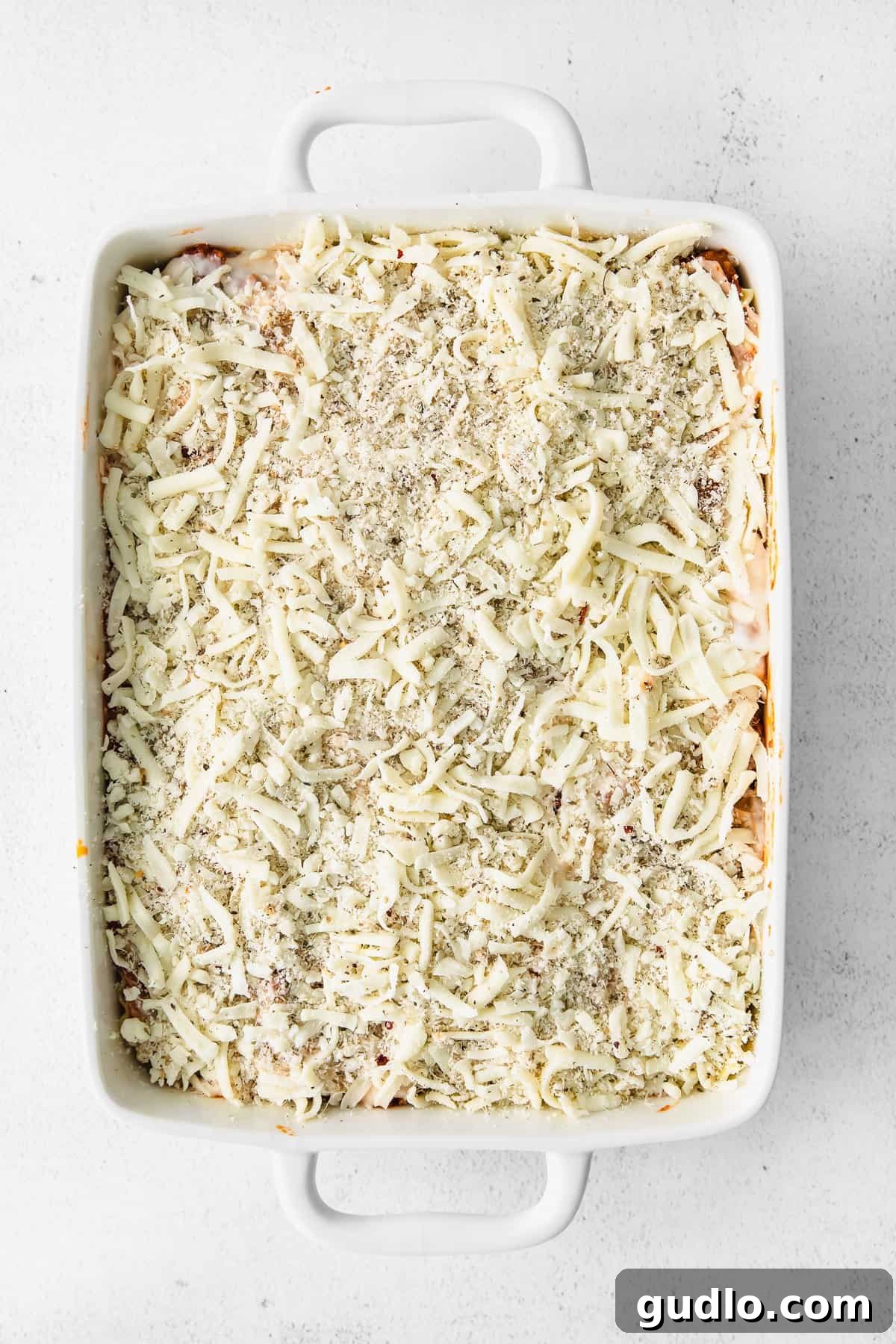 Lasagna Topped with Cheese The fully assembled and baked bechamel lasagna, generously topped with melted shredded cheese before being baked.
