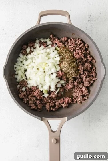 Creamy Bechamel Lasagna 5 Ground beef and onions sautéing in a frying pan for the lasagna meat sauce.