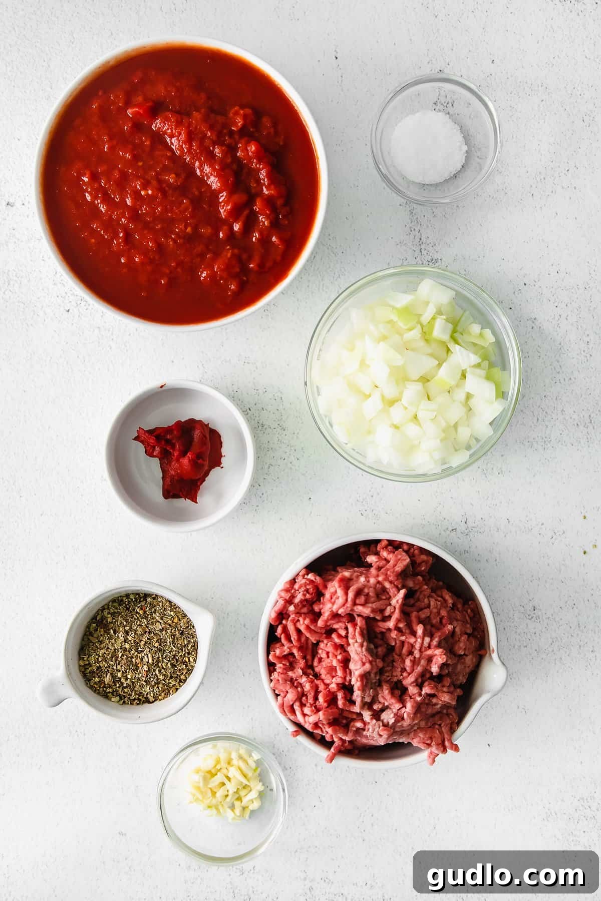 Fresh Ingredients for Meat Sauce A colorful array of ingredients for a hearty meat sauce, including fresh tomatoes, onions, garlic, and seasoning.