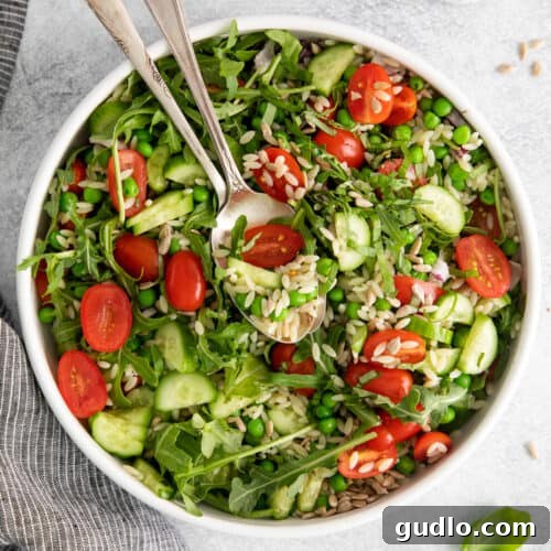 A vibrant and refreshing lemon orzo salad in a bowl, showcasing fresh ingredients.