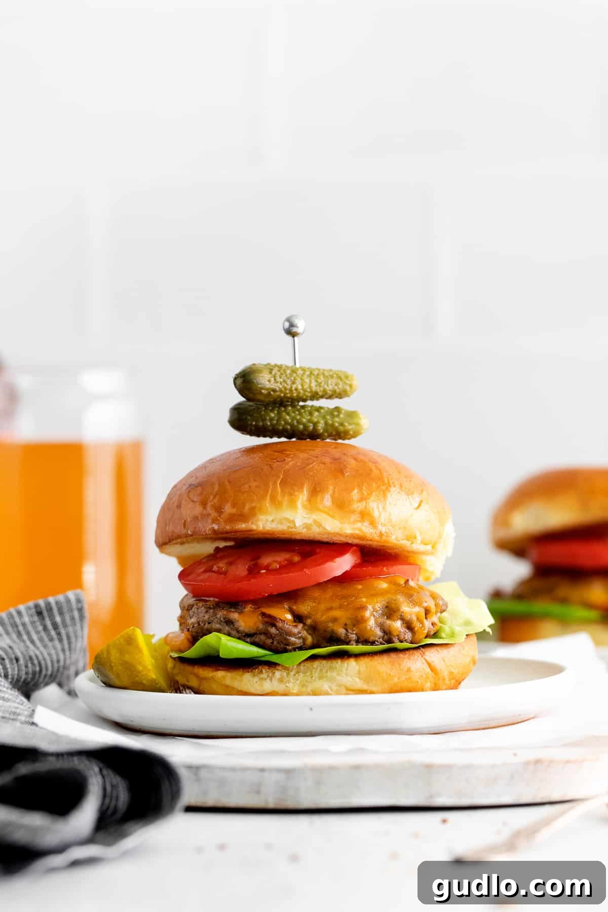 The Best Simple Cheeseburgers: Juicy & Easy Homemade Recipe A perfectly cooked cheeseburger on a white plate, ready to be enjoyed.
