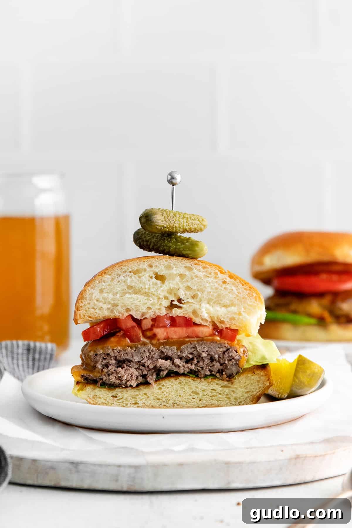 Delicious Homemade Cheeseburger Ready to Serve A freshly assembled, juicy cheeseburger on a plate, garnished and ready to eat.