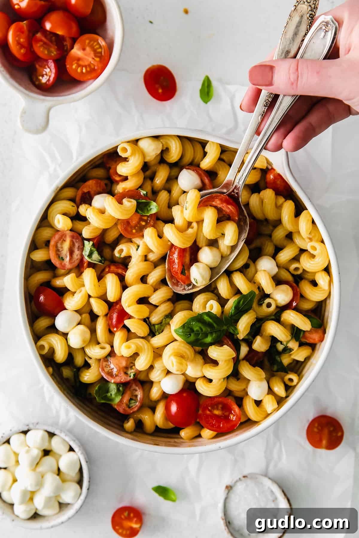 Vibrant Caprese Pasta Toss 6 A spoonful of Caprese Pasta Salad, showing the perfect blend of ingredients for a delicious bite.