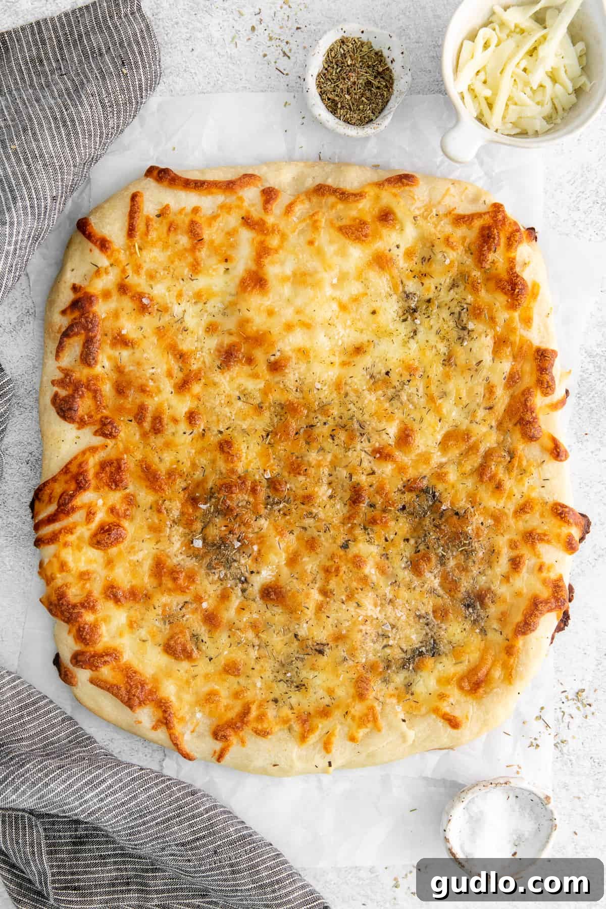 Golden Baked Cheese Bread Freshly baked homemade cheese bread, golden and bubbly, sliced and ready to serve.