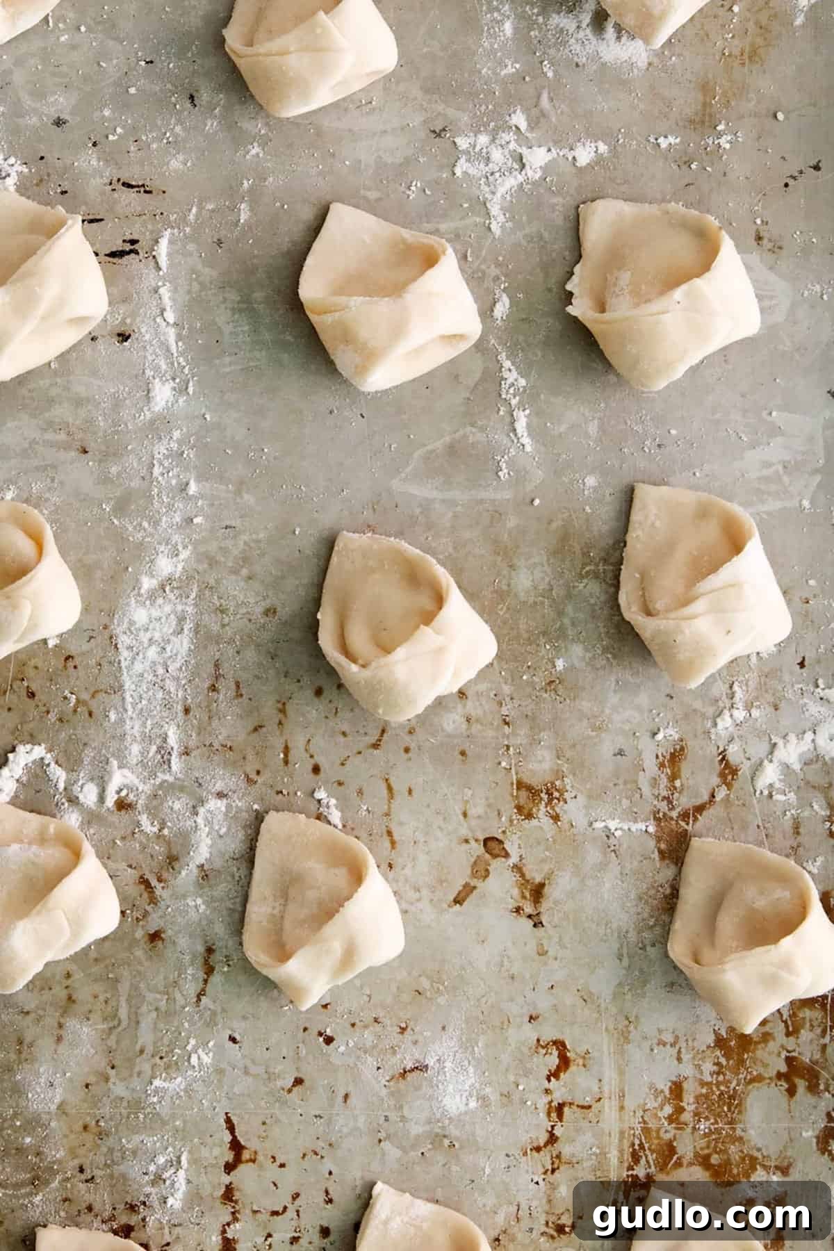 Cooked cheese tortellini glistening in a pot of simmering sauce, ready to serve.