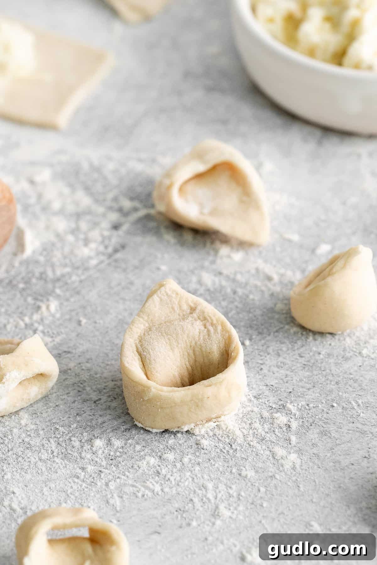 A generous serving of homemade tortellini on a cutting board, garnished and ready.