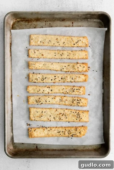 Savory Homemade Cheese Crisps 7 Freshly baked golden-brown cheese crackers cooling on a baking sheet, showcasing their perfect crispness and even baking.