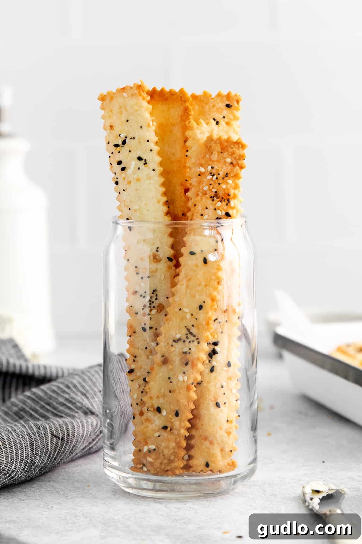 Cheese Crackers in Storage Jar Homemade cheese crackers charmingly arranged and stored in a clear glass jar, ready for easy snacking.