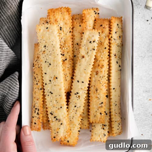 Crispy homemade cheese crackers served in a bowl, ready to enjoy as a delicious snack or appetizer.
