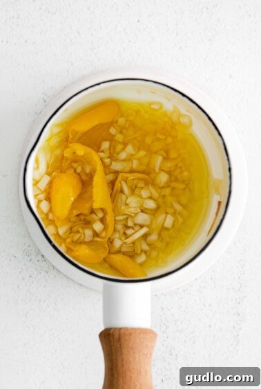 Garlic and lemon rind infusing in olive oil in a small pot.