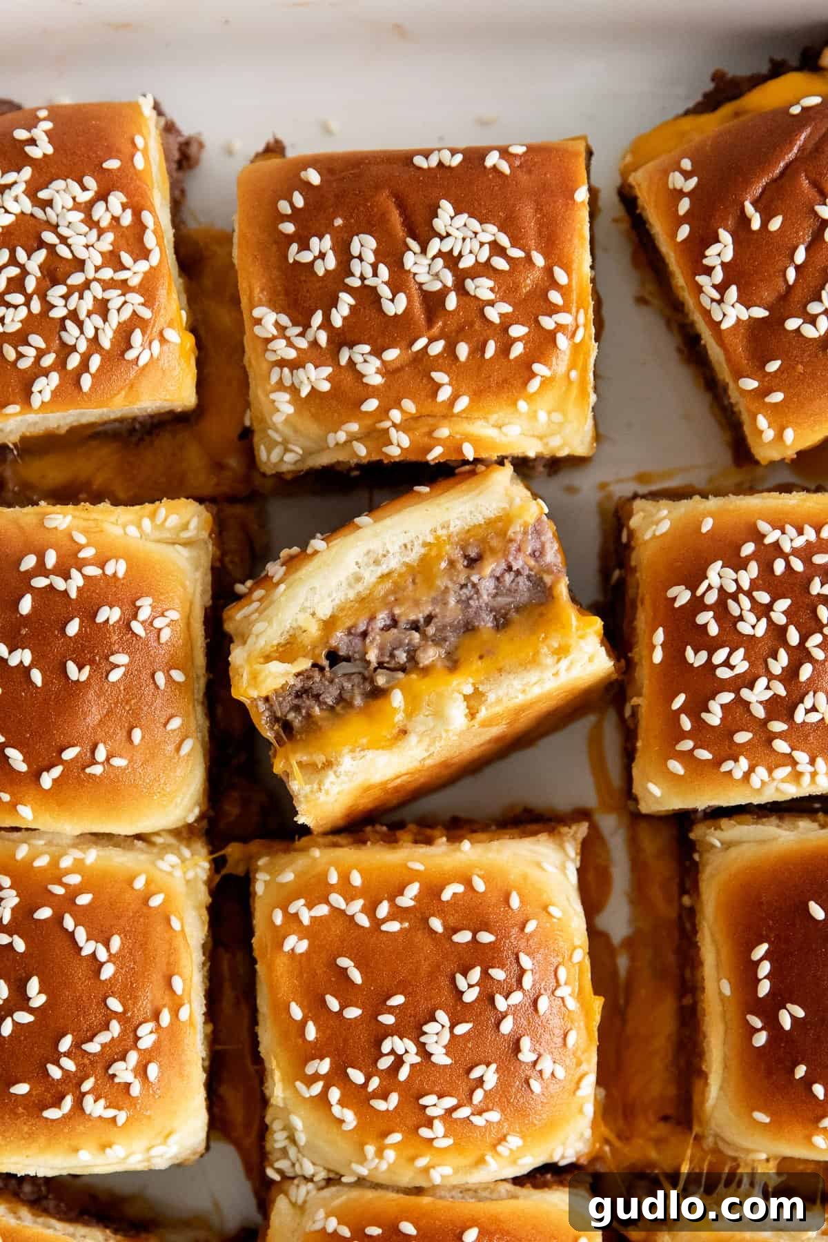 Easy Oven-Baked Hawaiian Roll Cheeseburger Sliders with Cheddar Delicious cheeseburger sliders baked in a casserole dish, ready to be served.