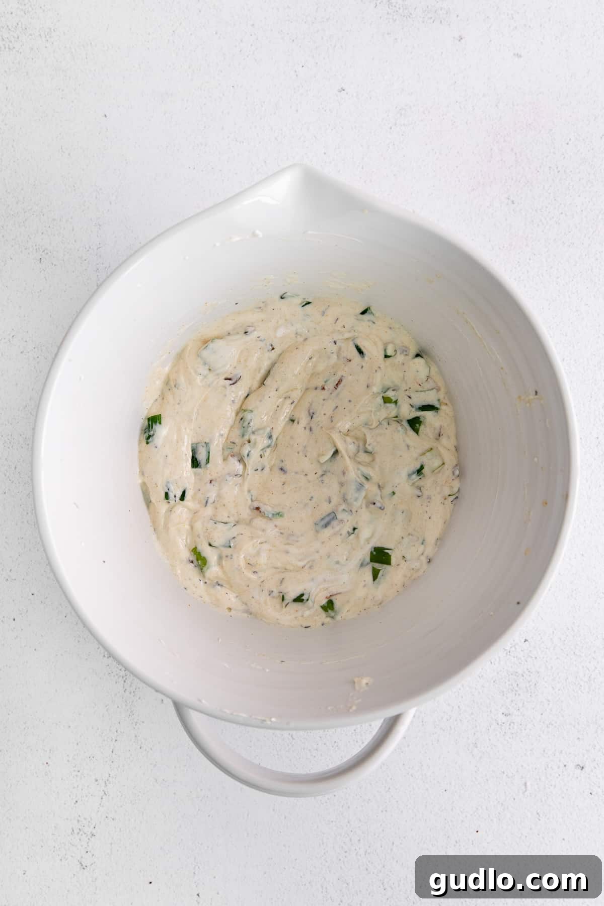 Toasted Green Onion Spread 6 A large bowl of Sizzling Scallion Dip resting on a wooden board, ready for serving.