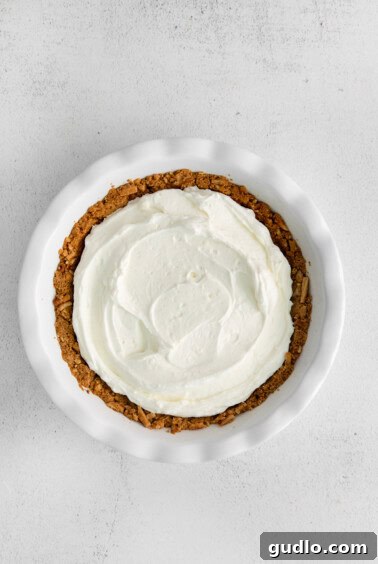 A strawberry cream cheese pie with whipped cream filling in a crust.
