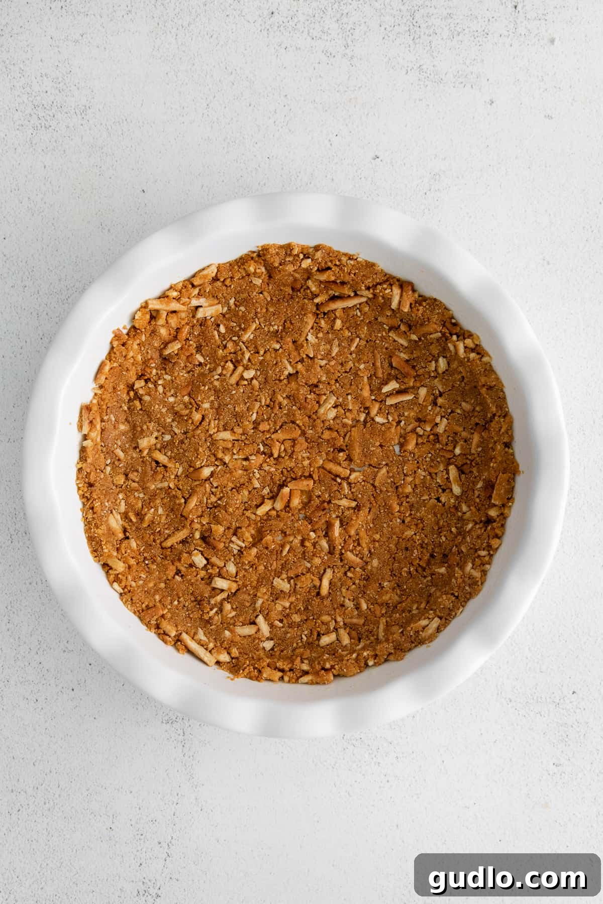 A perfectly baked pie crust, golden brown and ready for filling, sits in a pie plate.
