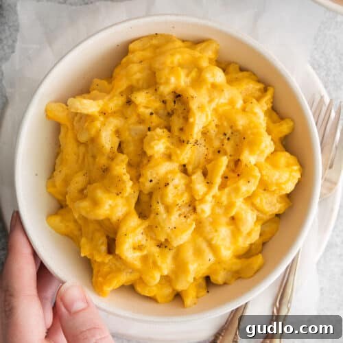 A delightful bowl of crockpot mac and cheese, perfectly golden and creamy, ready for serving.