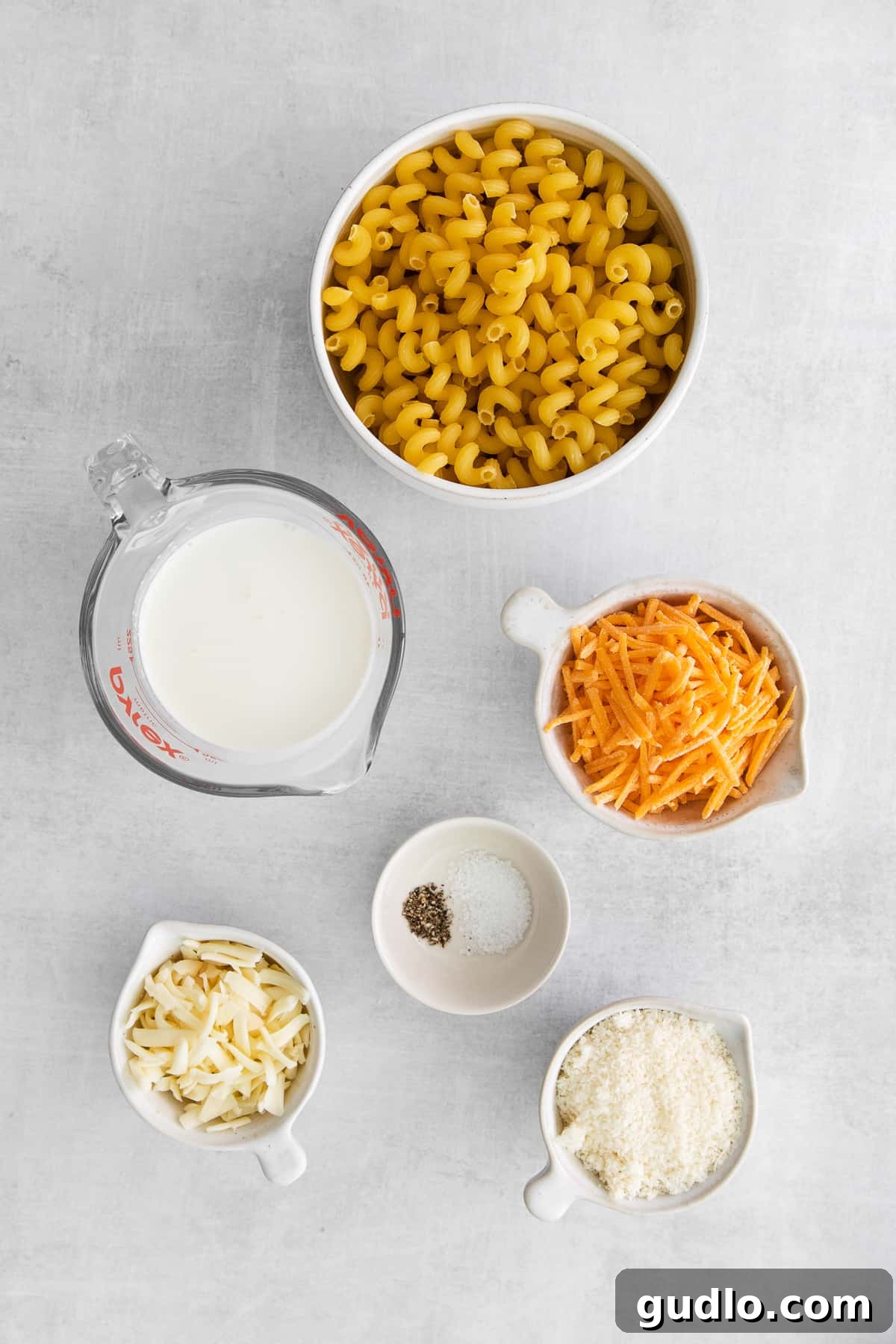 Key Ingredients for Cheese Pasta Ingredients for easy cheese pasta laid out in bowls, including pasta, cheese, and cream.