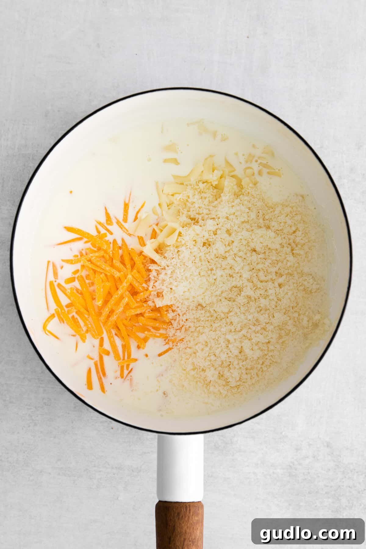 Making the Creamy Cheese Sauce Base Roux for cheese pasta being prepared in a stock pot, showing a creamy, light yellow mixture.
