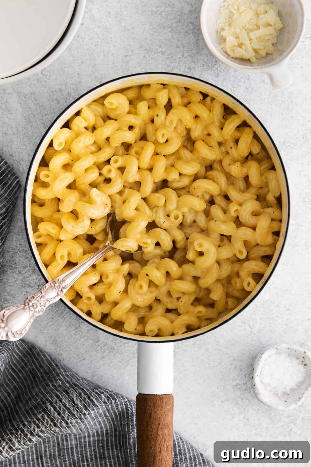 Creamy Pasta Ready to Serve Easy cheese pasta being scooped from a stock pot with a spoon, highlighting its creamy texture.