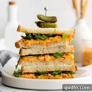 A stack of delicious pimento cheese sandwiches, highlighting the creamy filling.