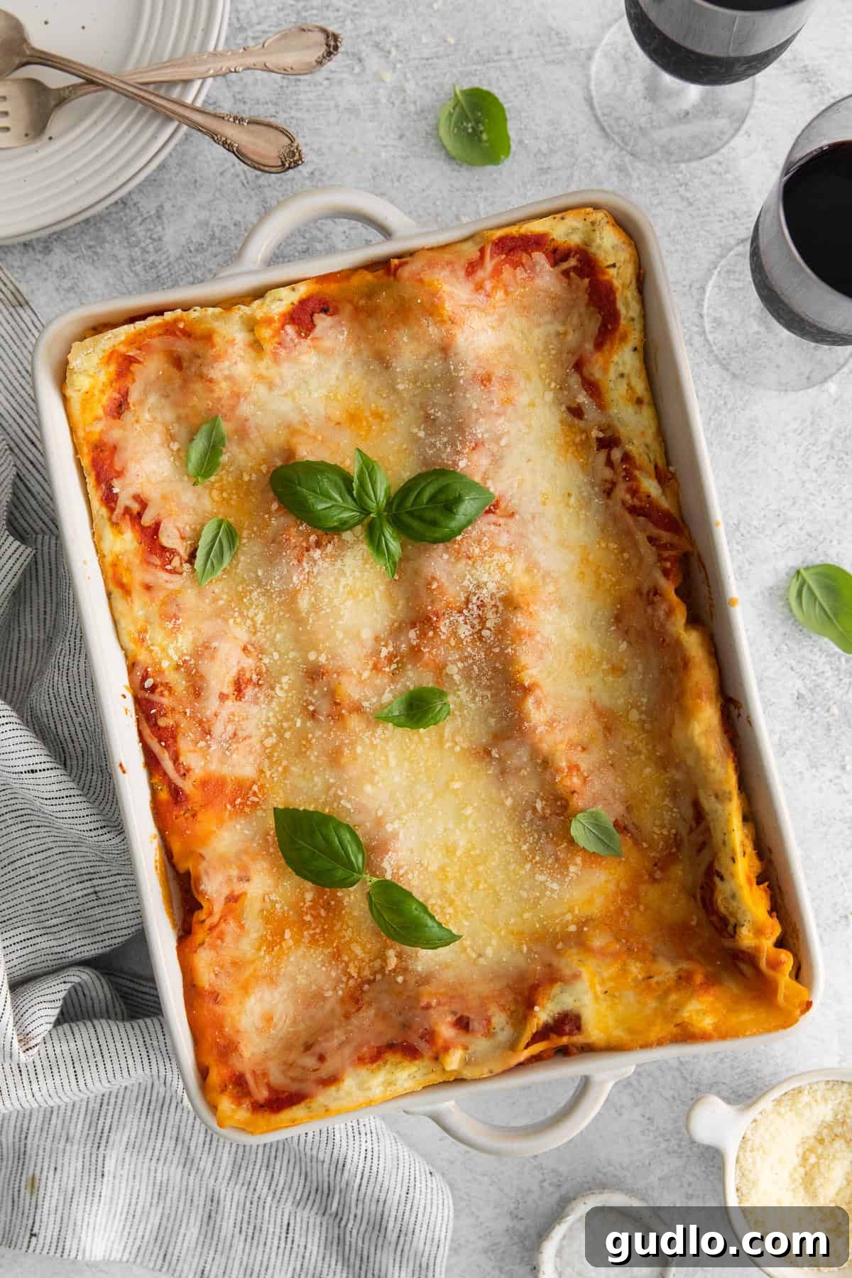 Cooked cheese lasagna in a pan. A steaming pan of cooked cheese lasagna, fresh out of the oven, with golden brown edges and melted, bubbly cheese on top.