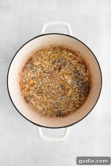 A pot filled with beans on a white background.
