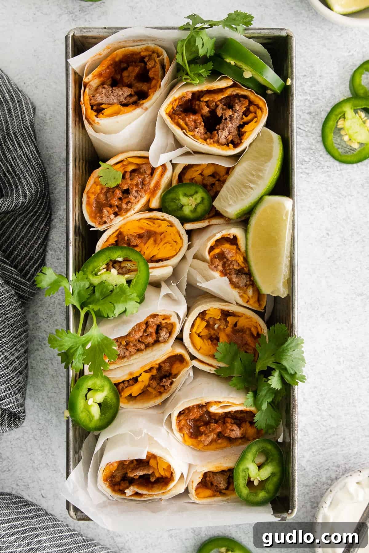 Delicious chili cheese burritos arranged in a dish, garnished with fresh cilantro.