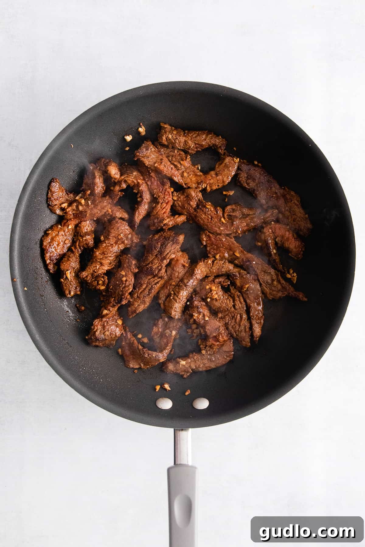 The ultimate steak quesadilla is made with flank steak, mushrooms, onion, and tons of Monterrey Jack cheese! Pan frying seasoned flank steak strips in a hot skillet.