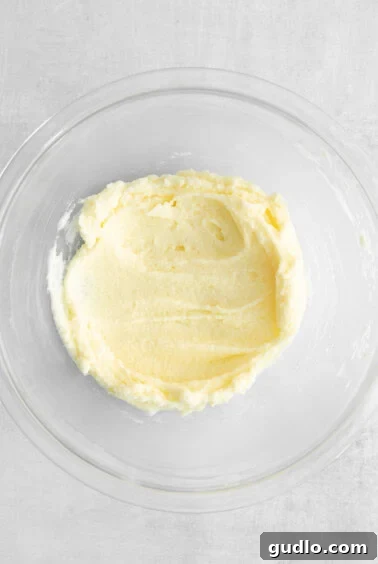 The smooth and creamy mascarpone mixture in a bowl, ready to be transferred to a piping bag.