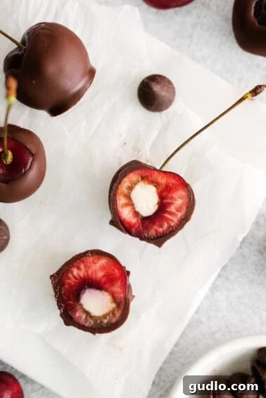Close-up of pitted cherries with creamy mascarpone filling being piped in, ready for chilling.